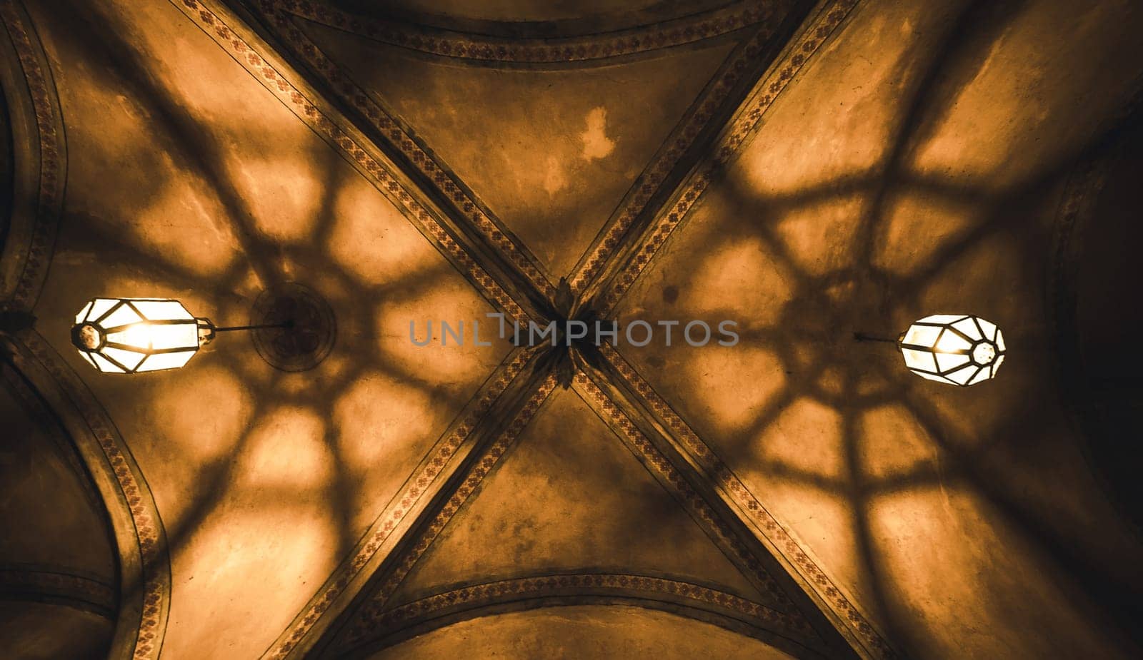 light from the lamp and the shadows in the mysterious arch