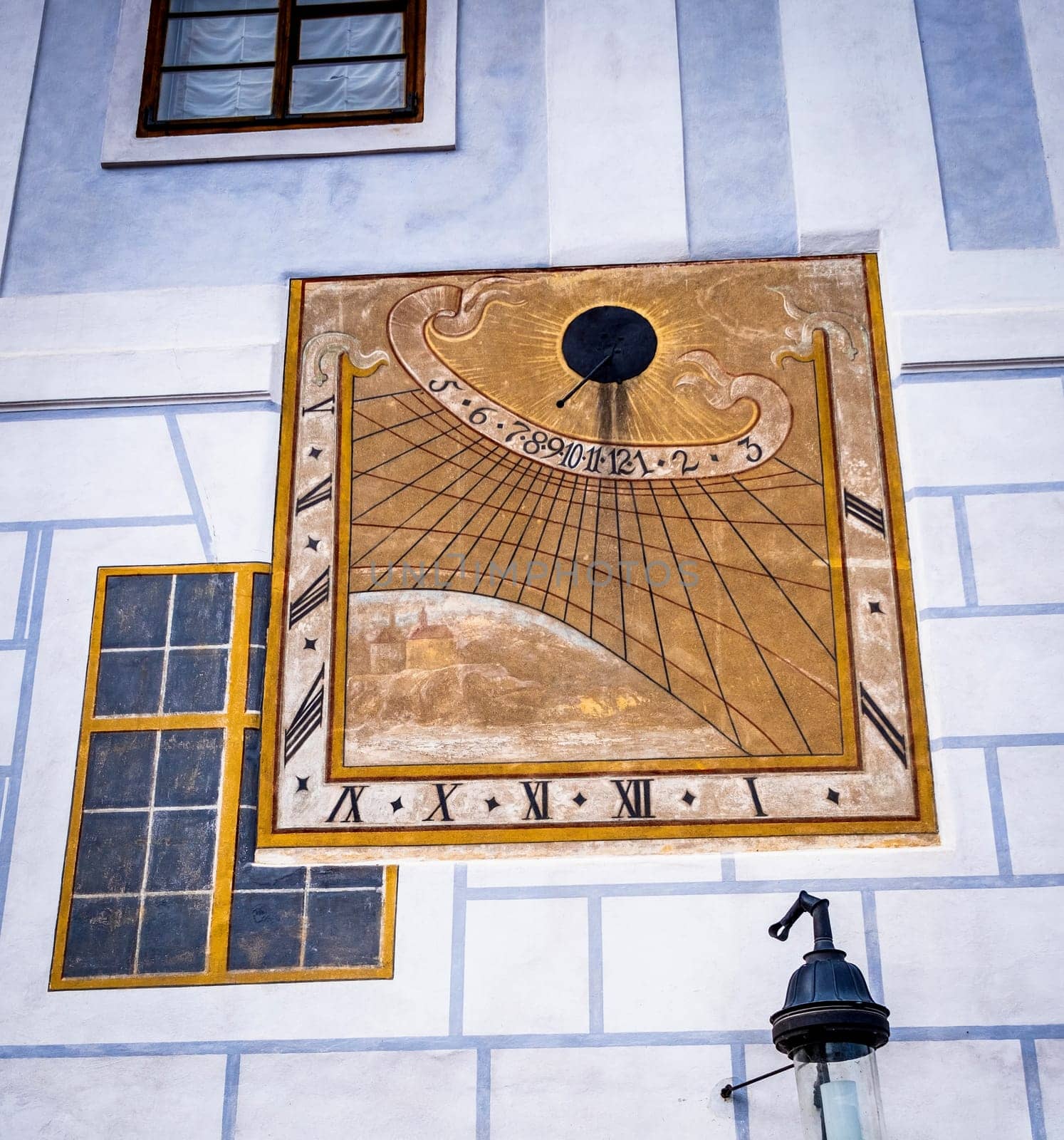 Anchient painted sun clock on the wall in Cesky Krumlov