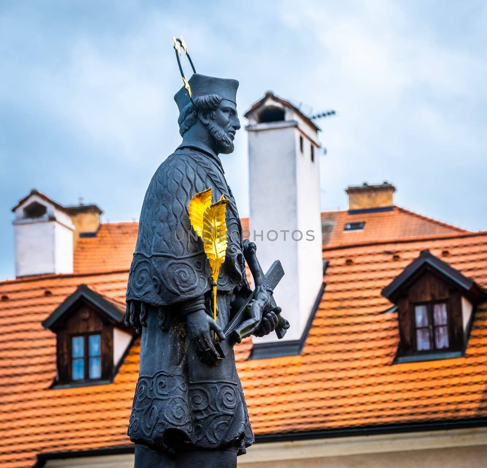 Bronze monument with golden leaves in Cesky Krumlov