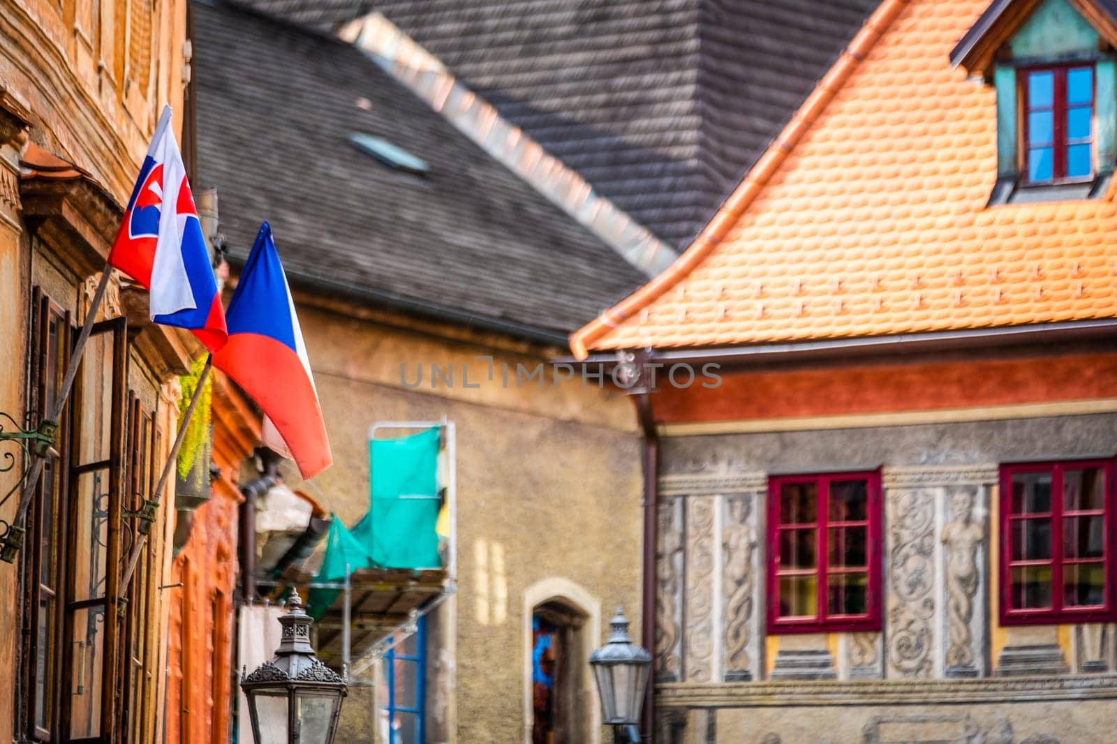 Side view of old building's architecture with nathional czech flags in Cesky Krumlov