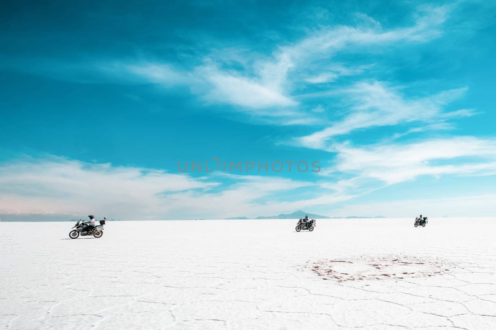 Group of bikers riding in Salar de Uyuni