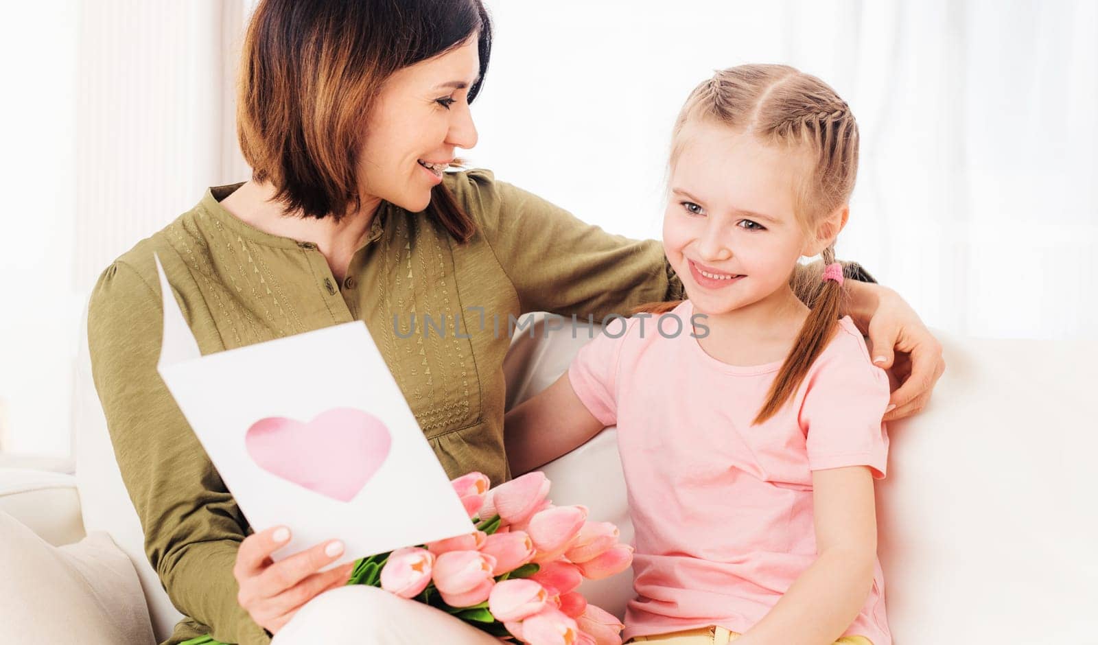 Beatiful mom likes opening nice daughters presents for Mothers day