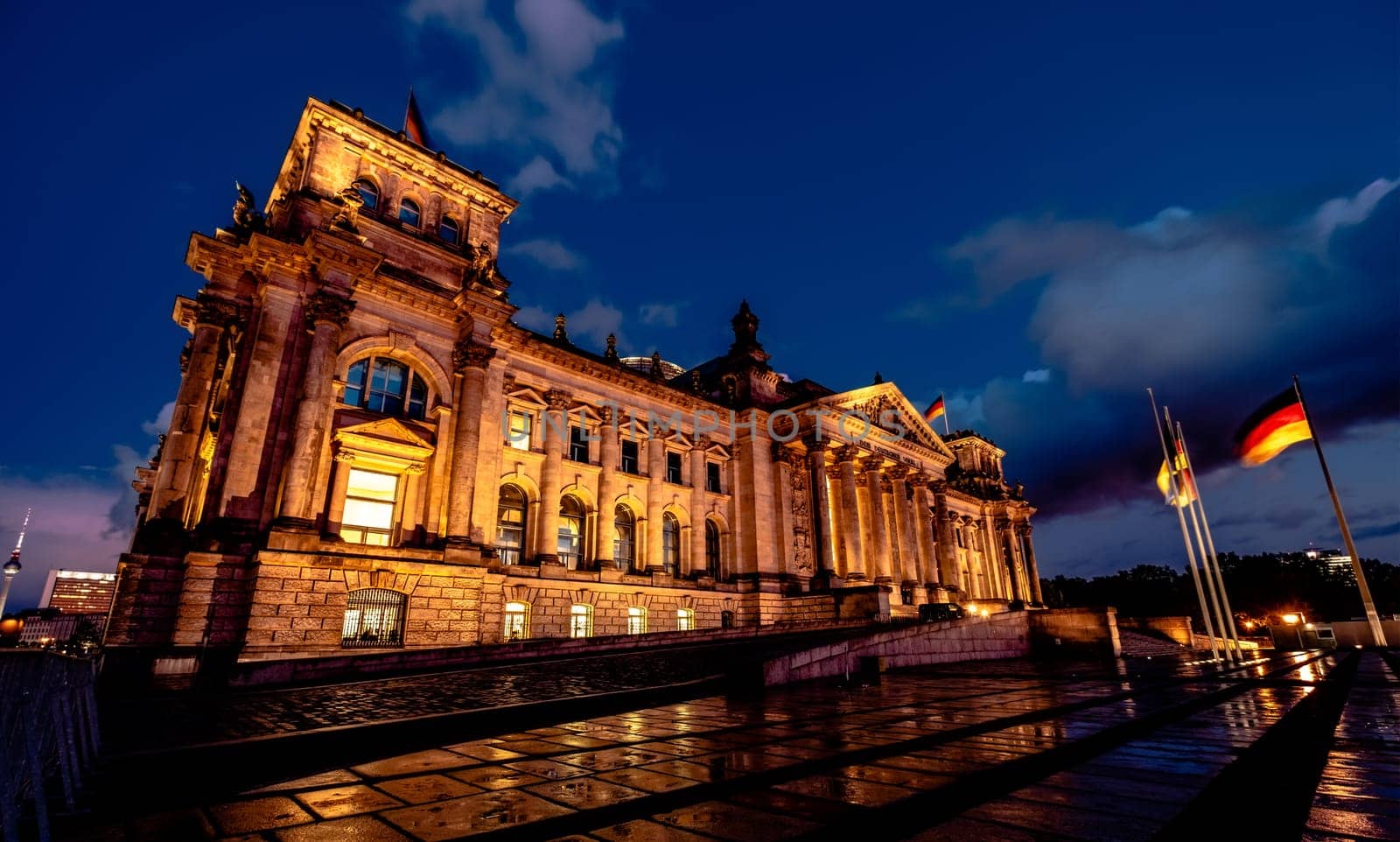 Famous Reichstag with german flags in evening