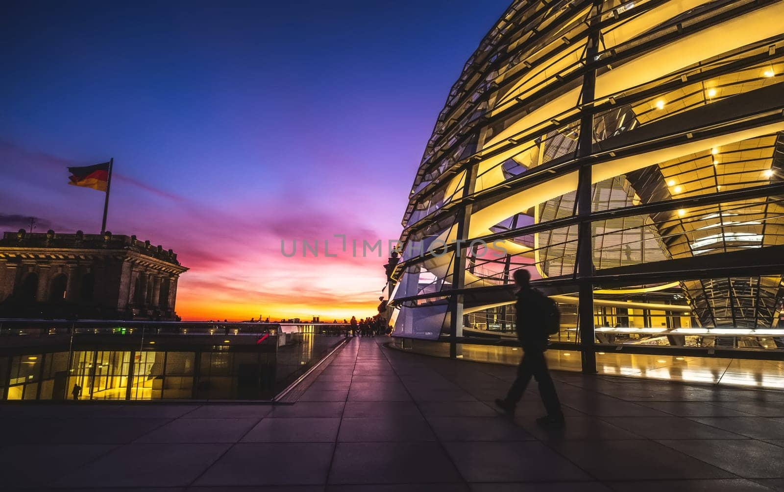 Lonely tourist walking along evening Reichstag