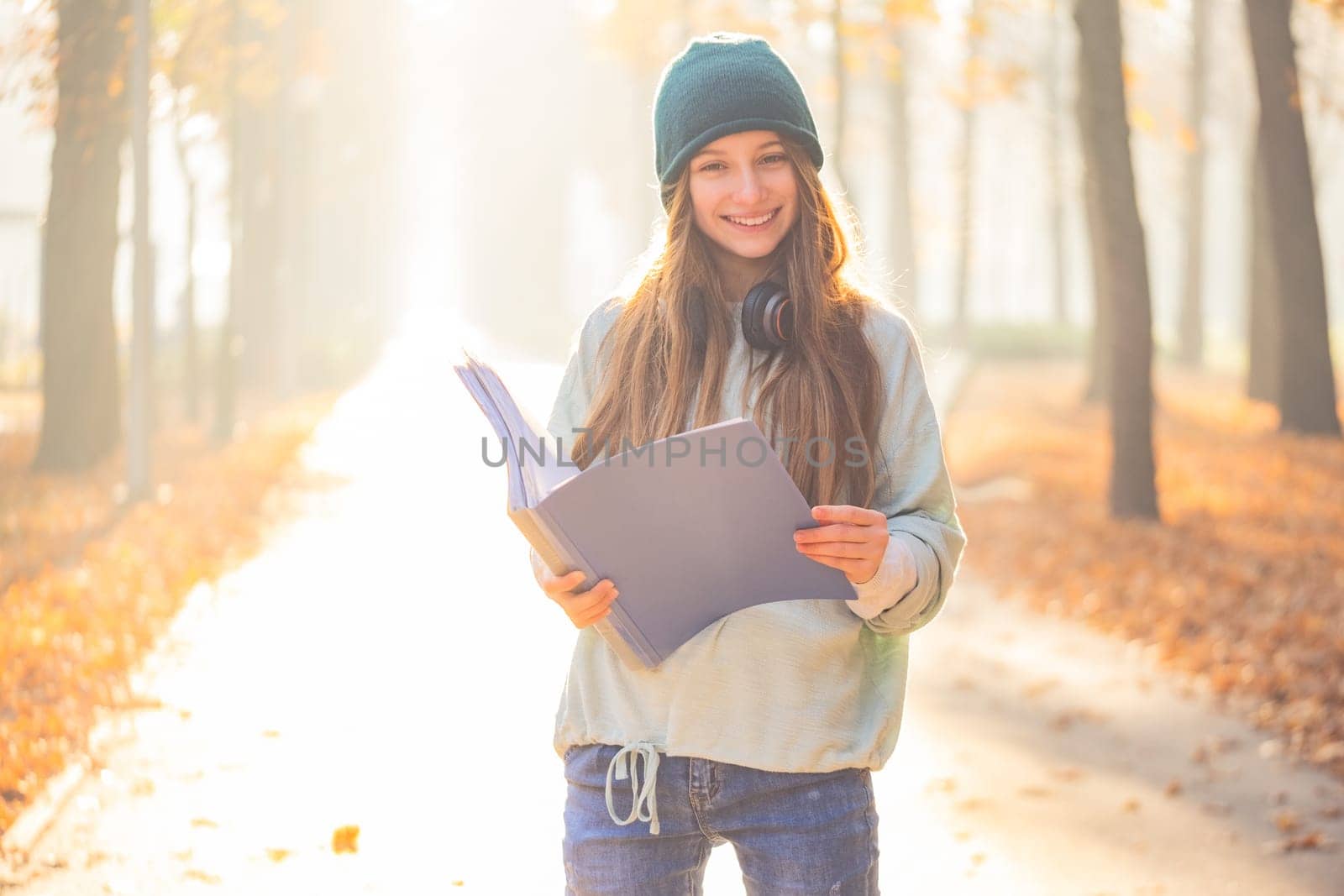 Cute teenage girl reading in park by GekaSkr