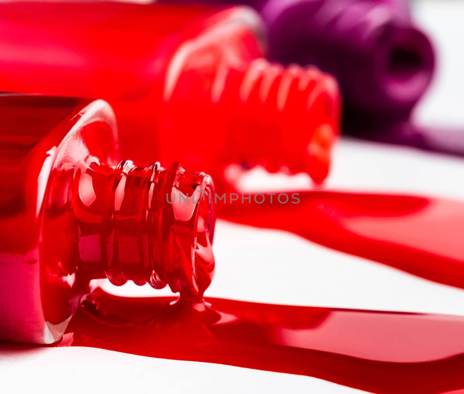 Red splash from nail polish bottle isolated