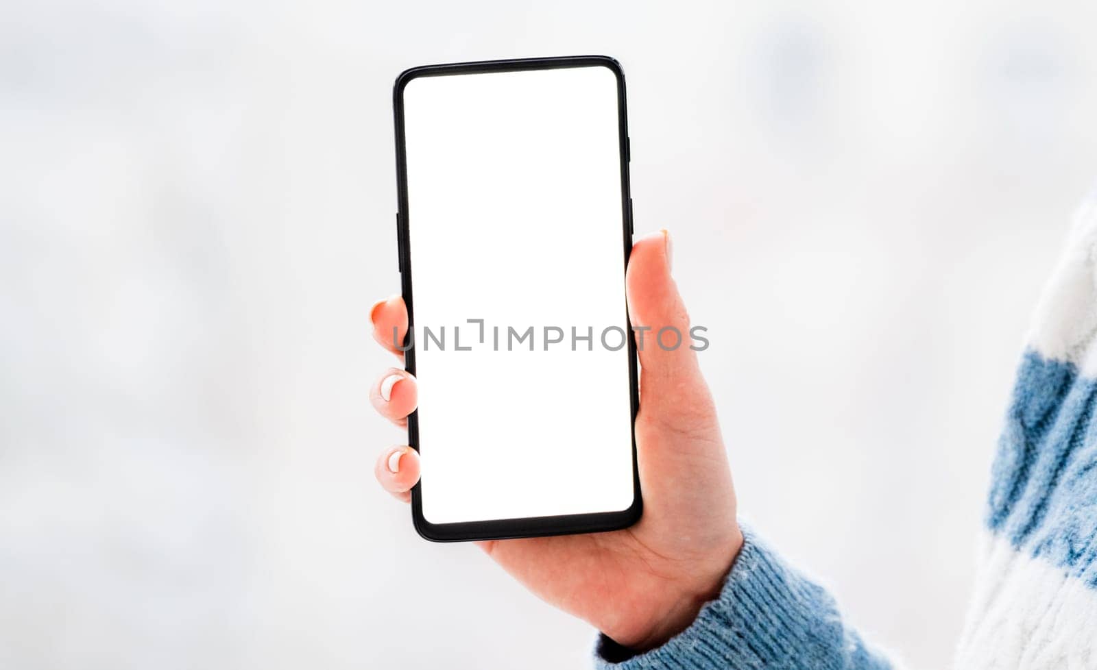 Hand holding mobile phone with white screen