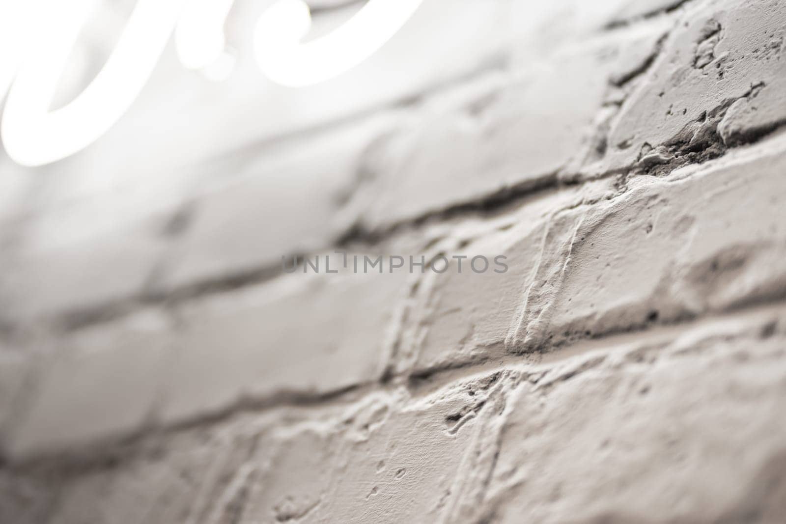 Close up view of textured brick wall with illumination