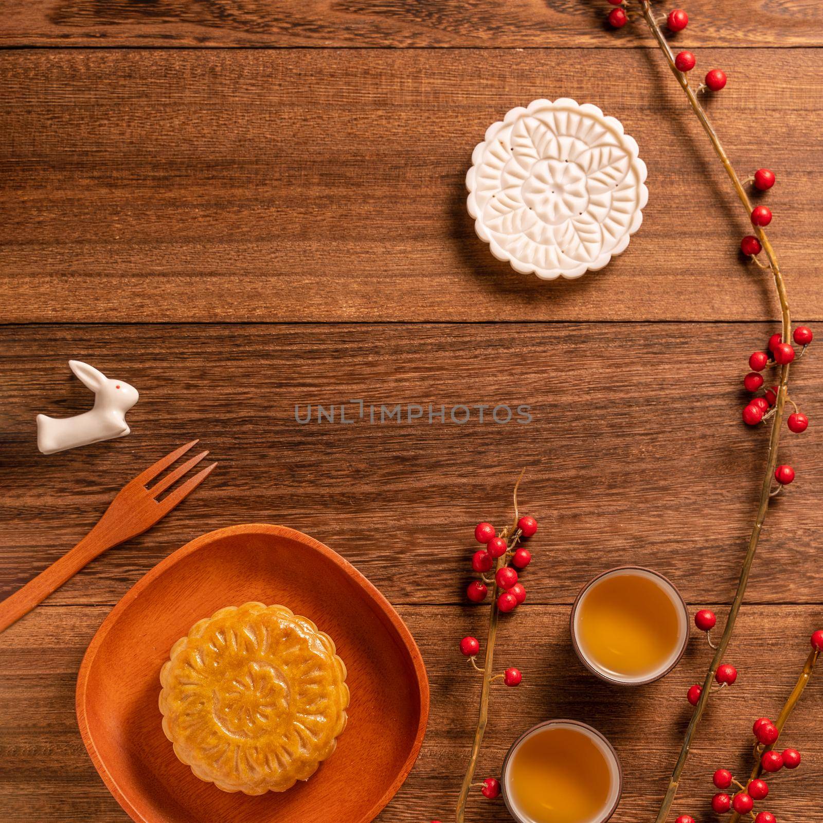 Creative Moon cake Mooncake table design - Chinese traditional pastry with tea cups on wooden background, Mid-Autumn Festival concept, top view, flat lay.