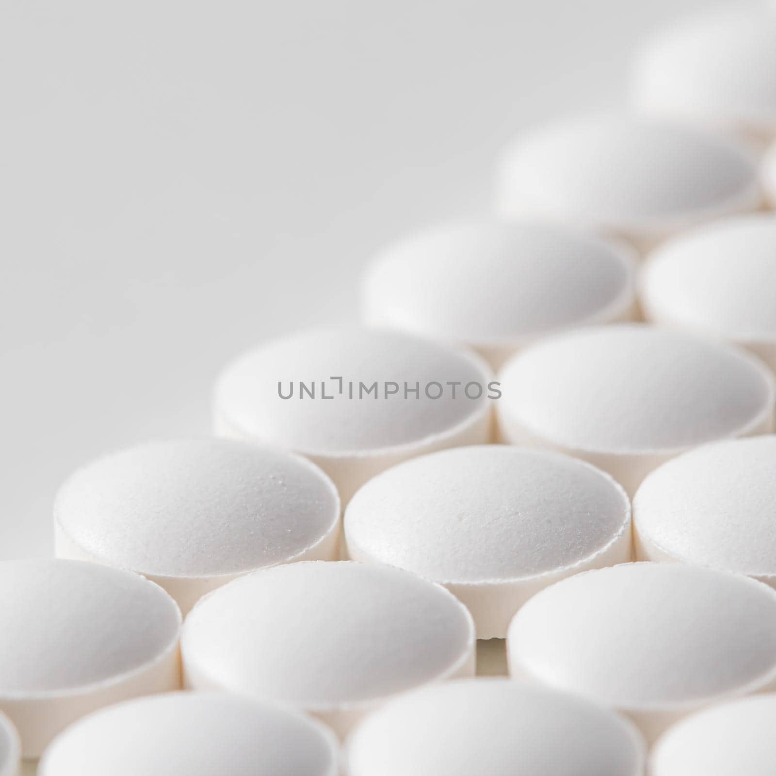 Rows of pills on a white background. Health care, medicine, pharmacy and disease concept