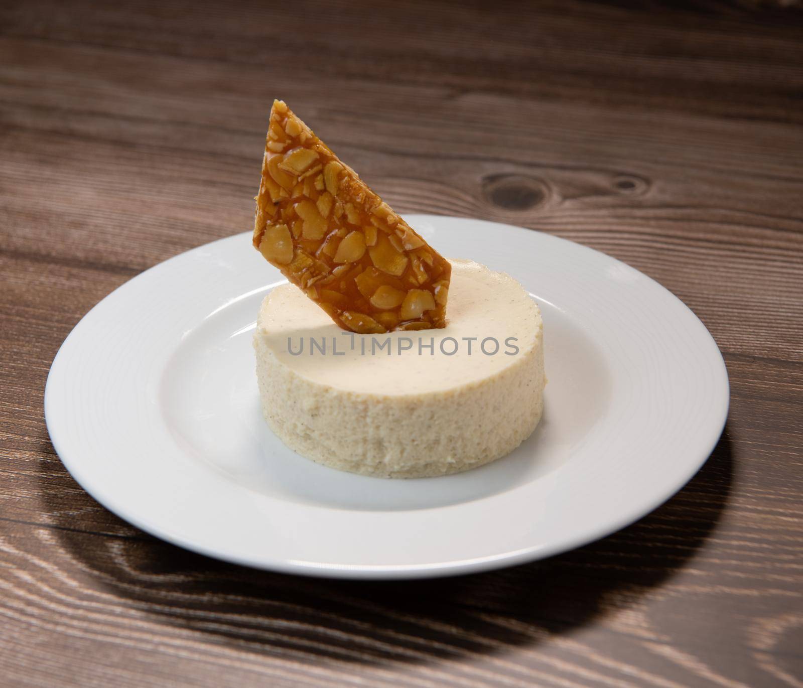Bavarian recipe with pear and vanilla served with almond nougatine. High quality photo