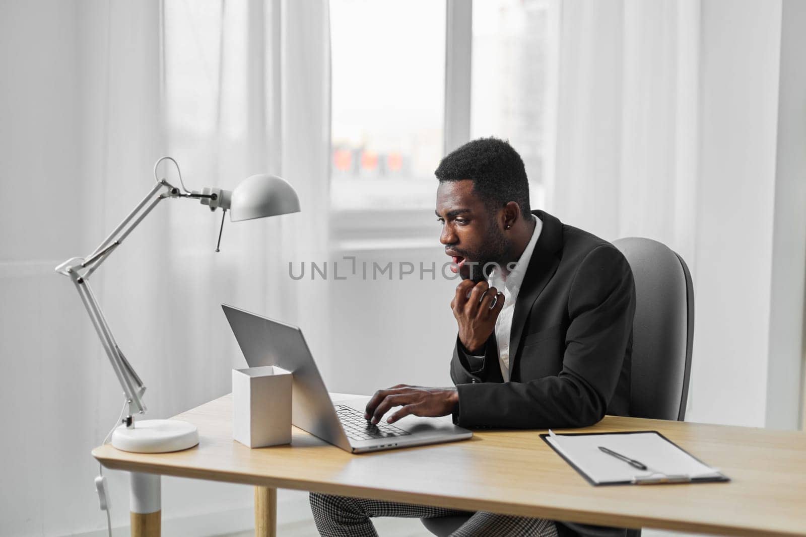 american man laptop online african education computer smiling student office job freelancer by SHOTPRIME