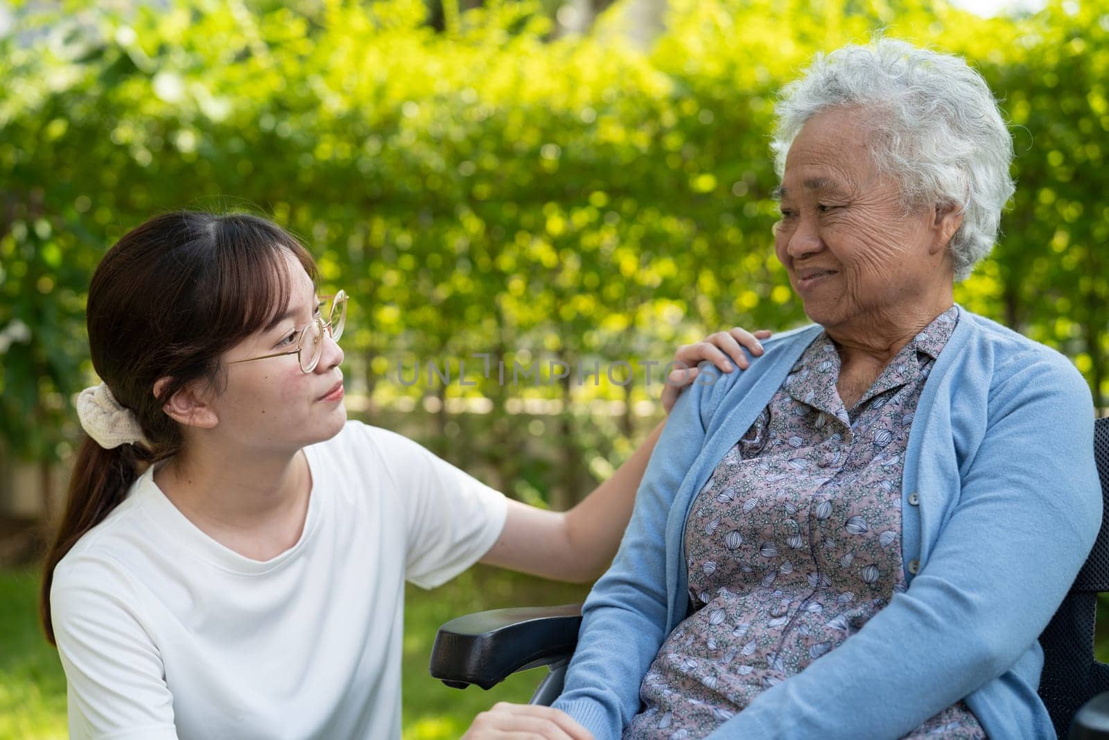 caregiver help and care Asian senior woman patient sitting on wheelchair at nursing hospital ward, healthy strong medical concept.