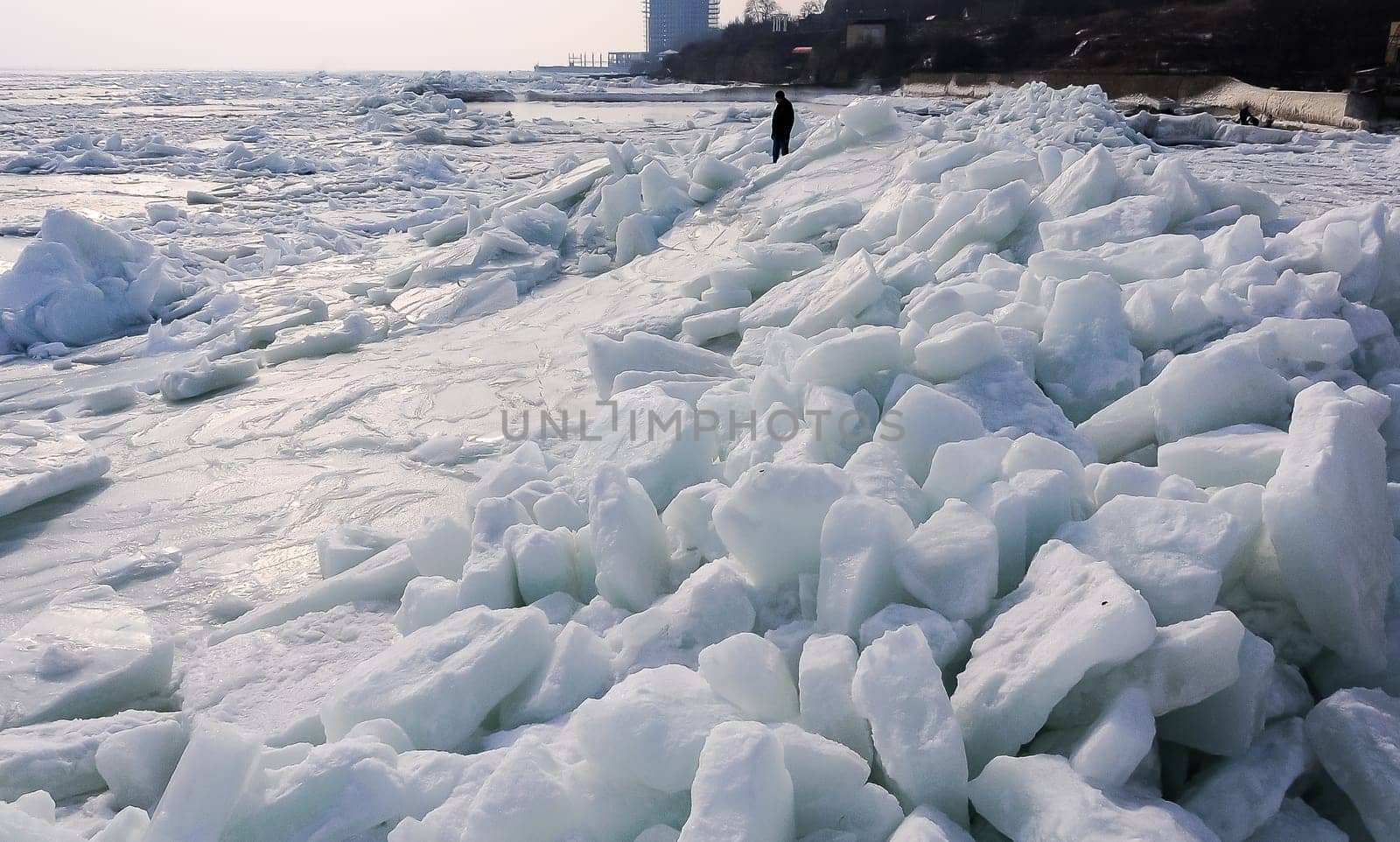 Ice Climatic collapse, heaps of ice blocks on the piers and the shore. The Black Sea near Odessa is frozen