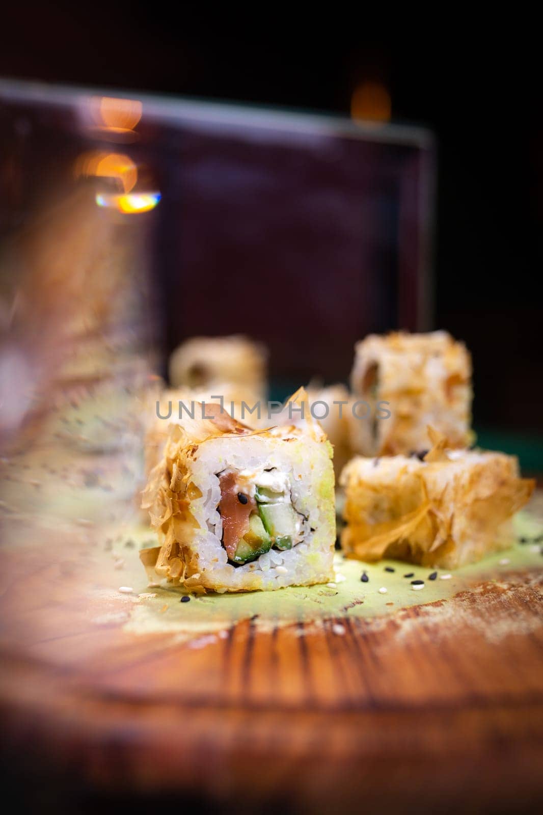 warm rolls on a wooden board with wasabi by Pukhovskiy