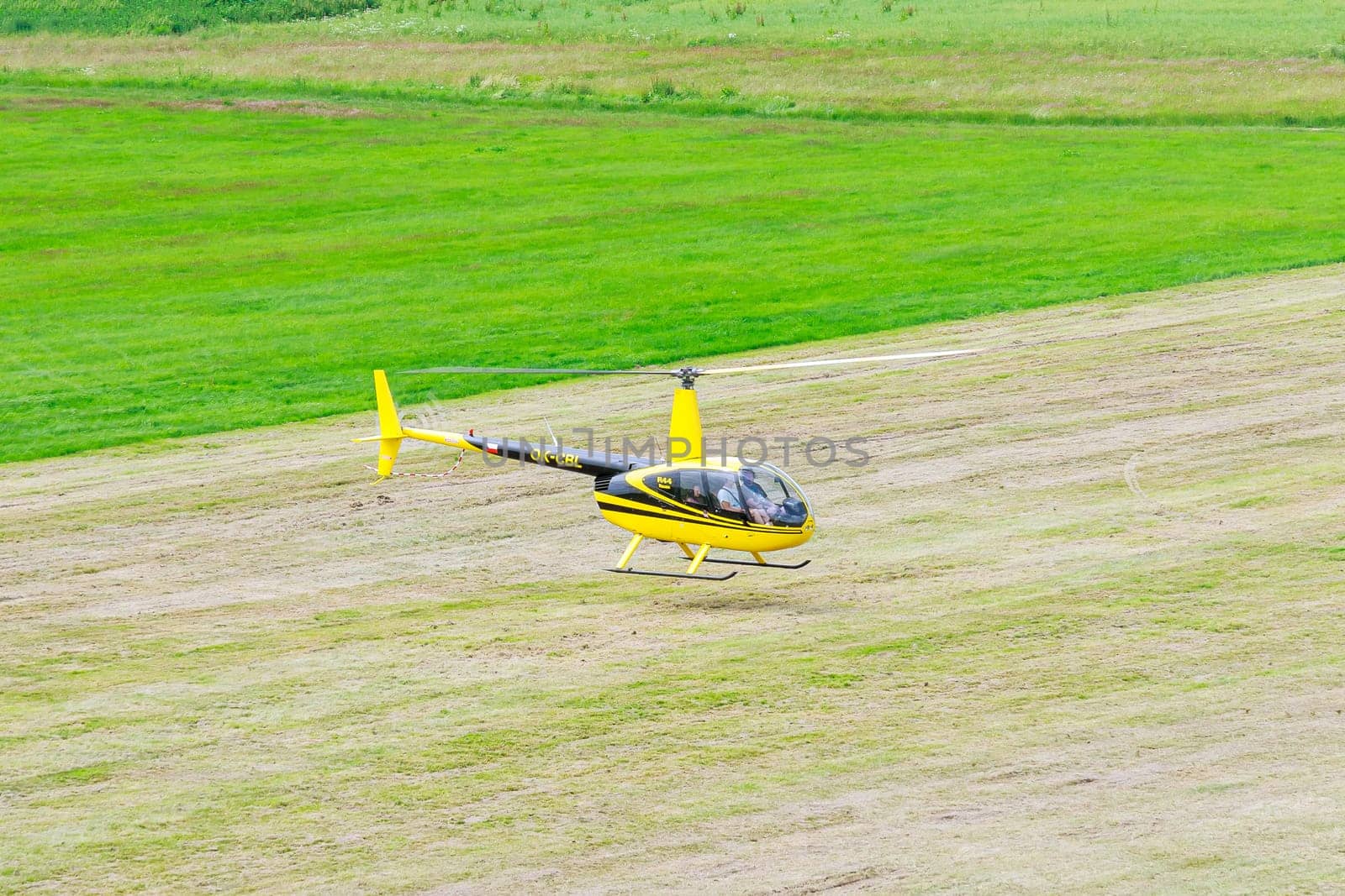 15 July 2021 Skutec, Czech Republic. Helicopter descended gently, touching down on the field with precision. Pilot conducted pre-flight check before taking helicopter off ground.