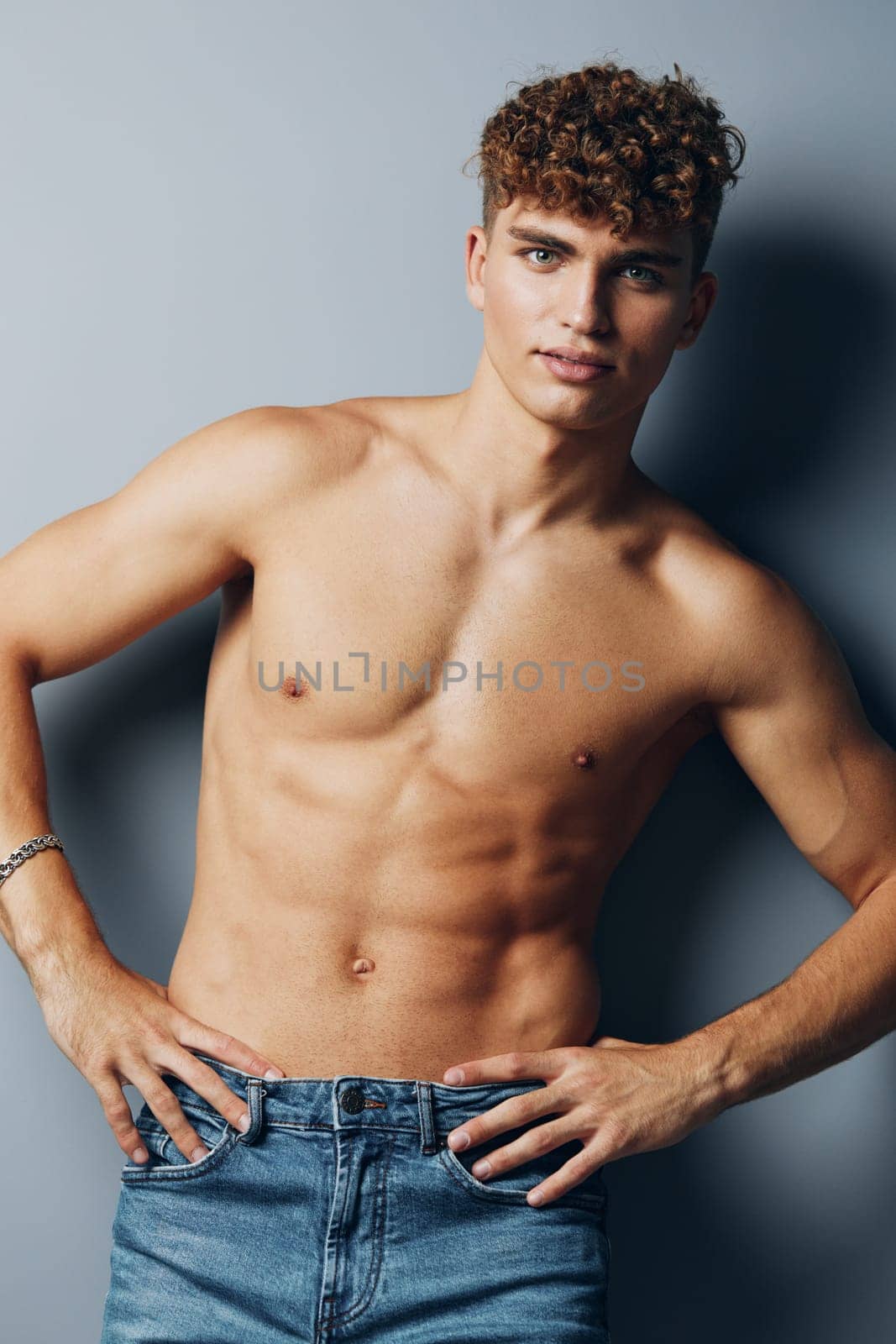 man care athletic sexy model gray background handsome person beauty adult male jeans by SHOTPRIME