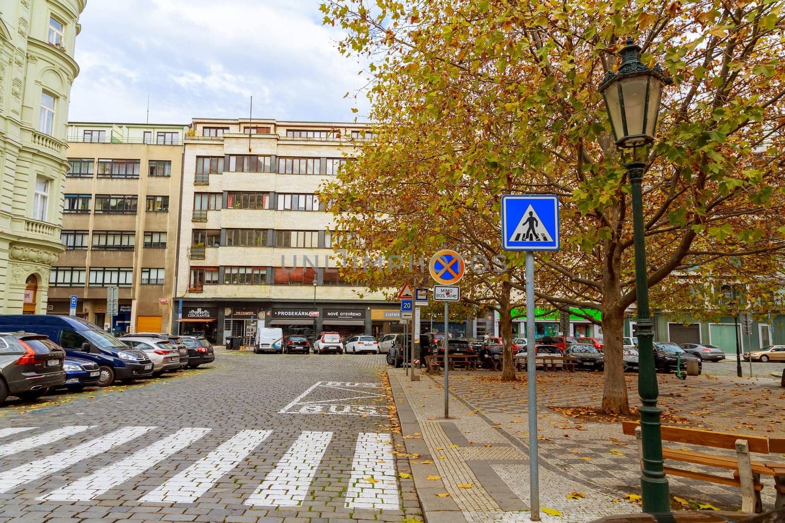 11 November 2022 Prague, Czech Republic. Street and parking for cars in the city, many signs and a pedestrian crossing.