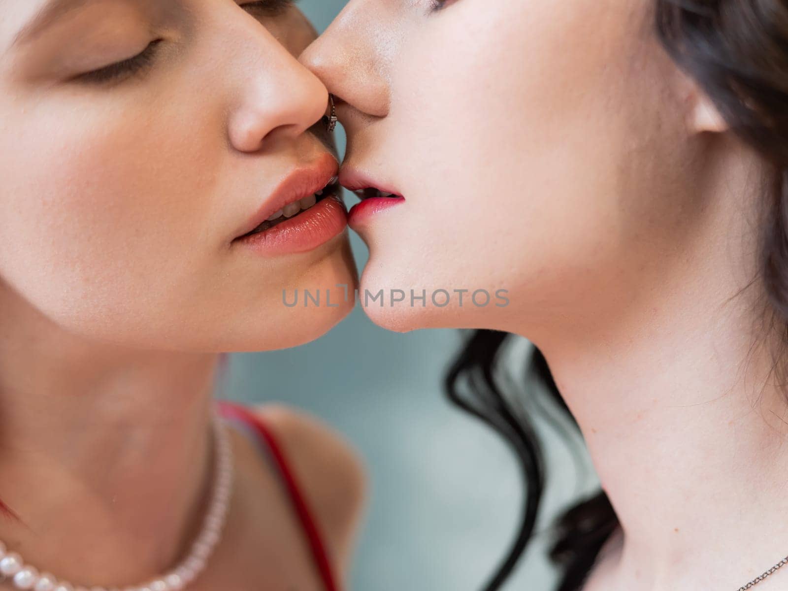 Close-up portrait of kissing Caucasian women. same sex love