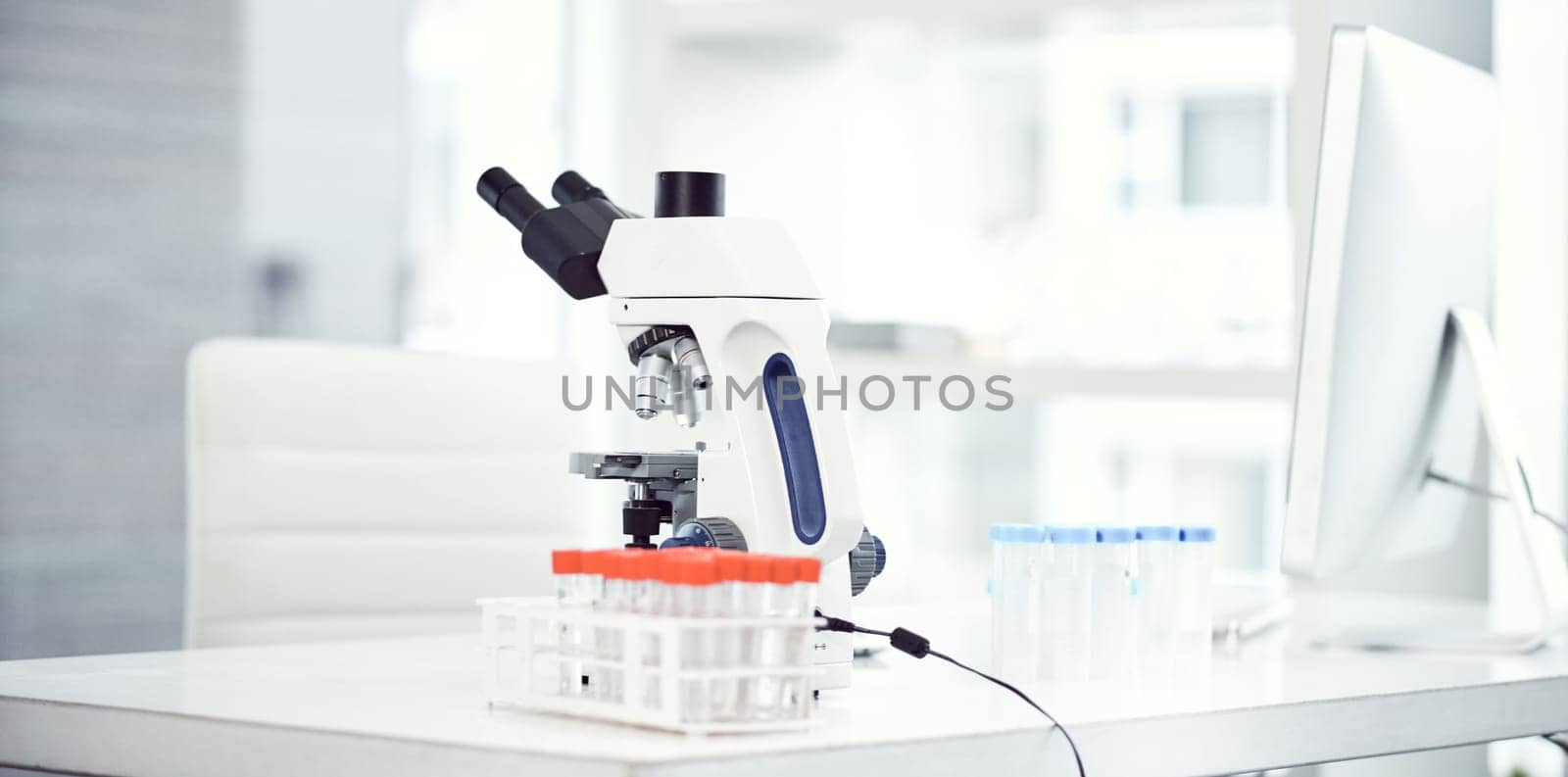 Science is worth exploring. a desk with scientific equipment on it inside of a laboratory. by YuriArcurs