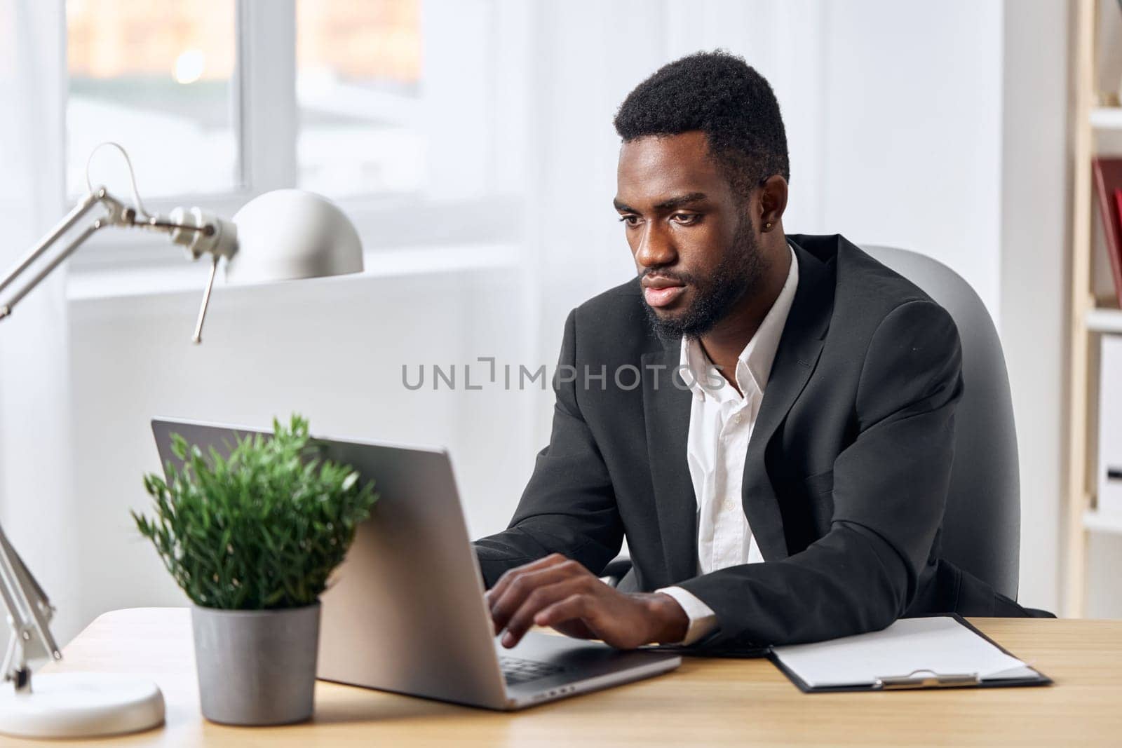 man education internet technology online corporate computer conference office american freelancer job work indoor business american distance student smiling laptop worker african