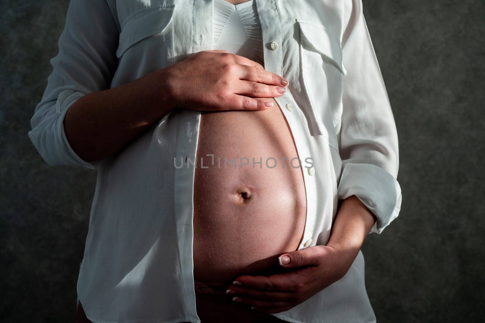 Belly of a pregnant woman. Pregnancy concept. by Mariakray