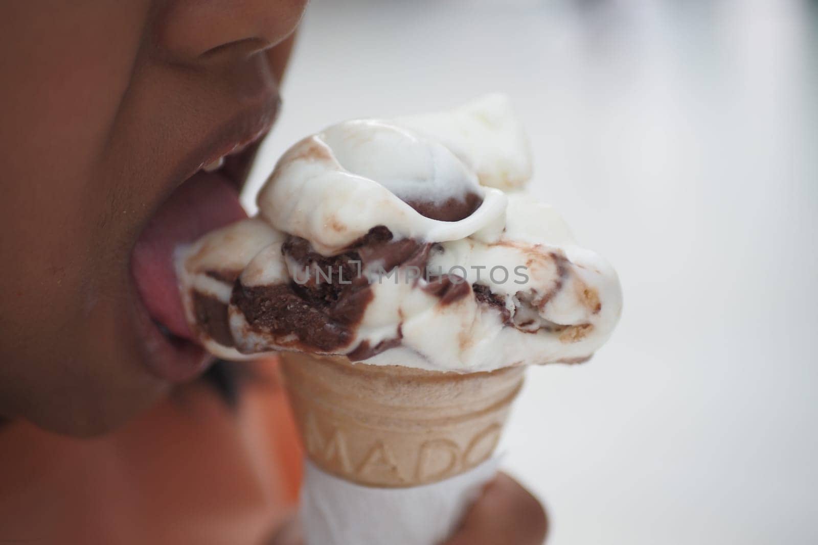 Child Hand Holding Vanilla Ice Cream in A Waffle Cone