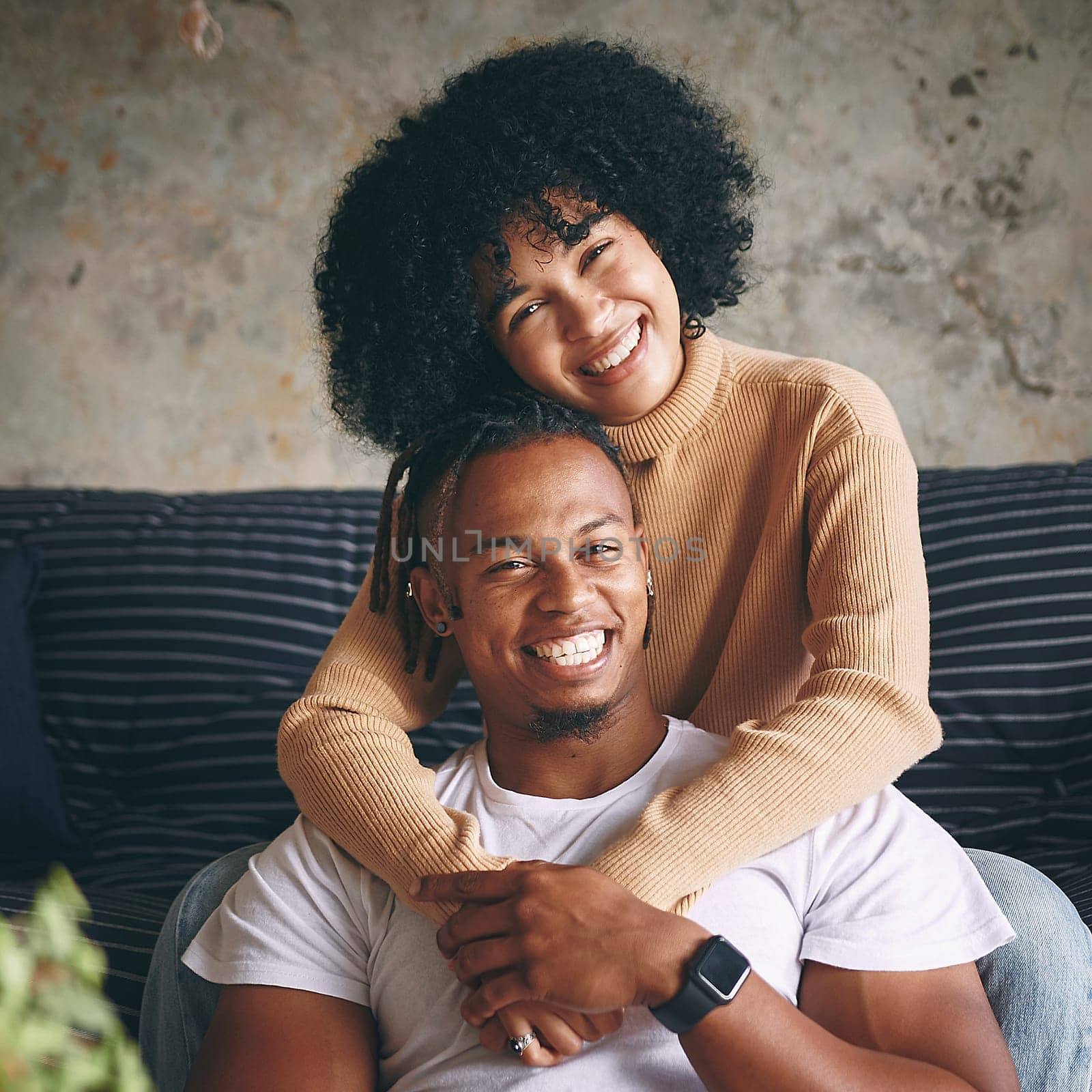 Lovers and best friends at the same time. Portrait of a young couple relaxing together at home. by YuriArcurs