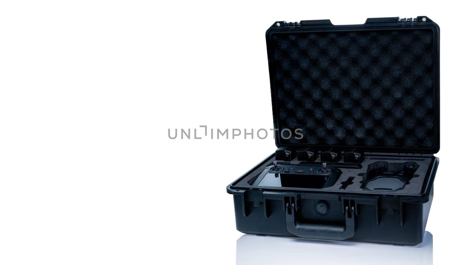 Drone and accessories in plastic case isolated on white background. UAV or unmanned aerial vehicle and drone accessories in protective travel case. LiPo rechargeable battery in storage container. by Fahroni