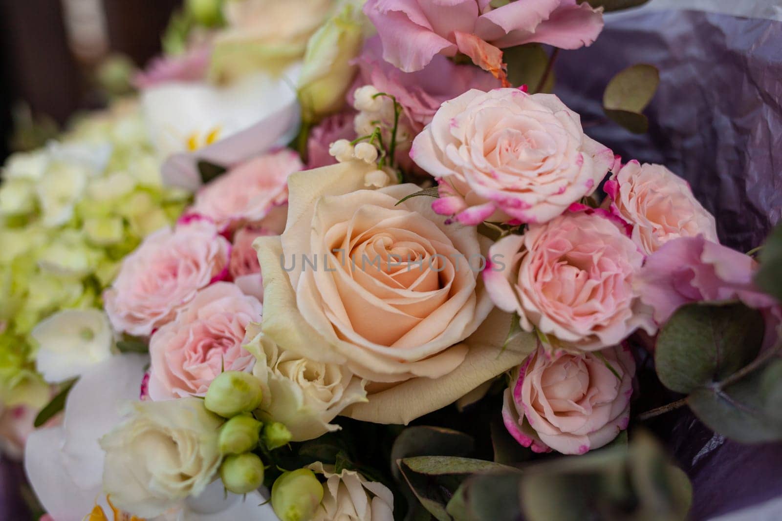 Wedding bouquet close-up. Flower gift for a person. Composition of flowers in a bouquet.