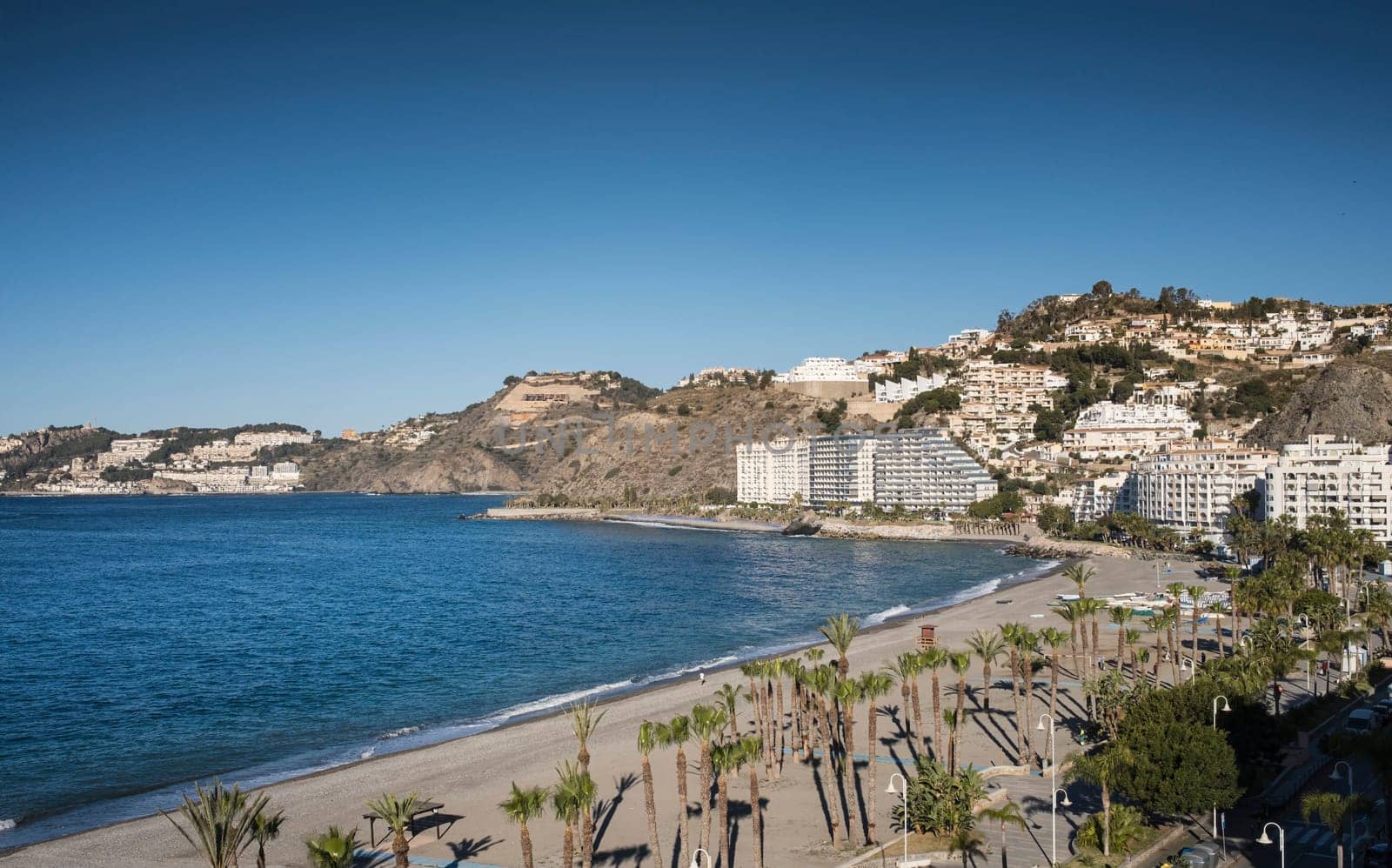 Scenic View of Almunecar Beach and Coastal Townscape with Modern Touristic Buildings. by csbphoto