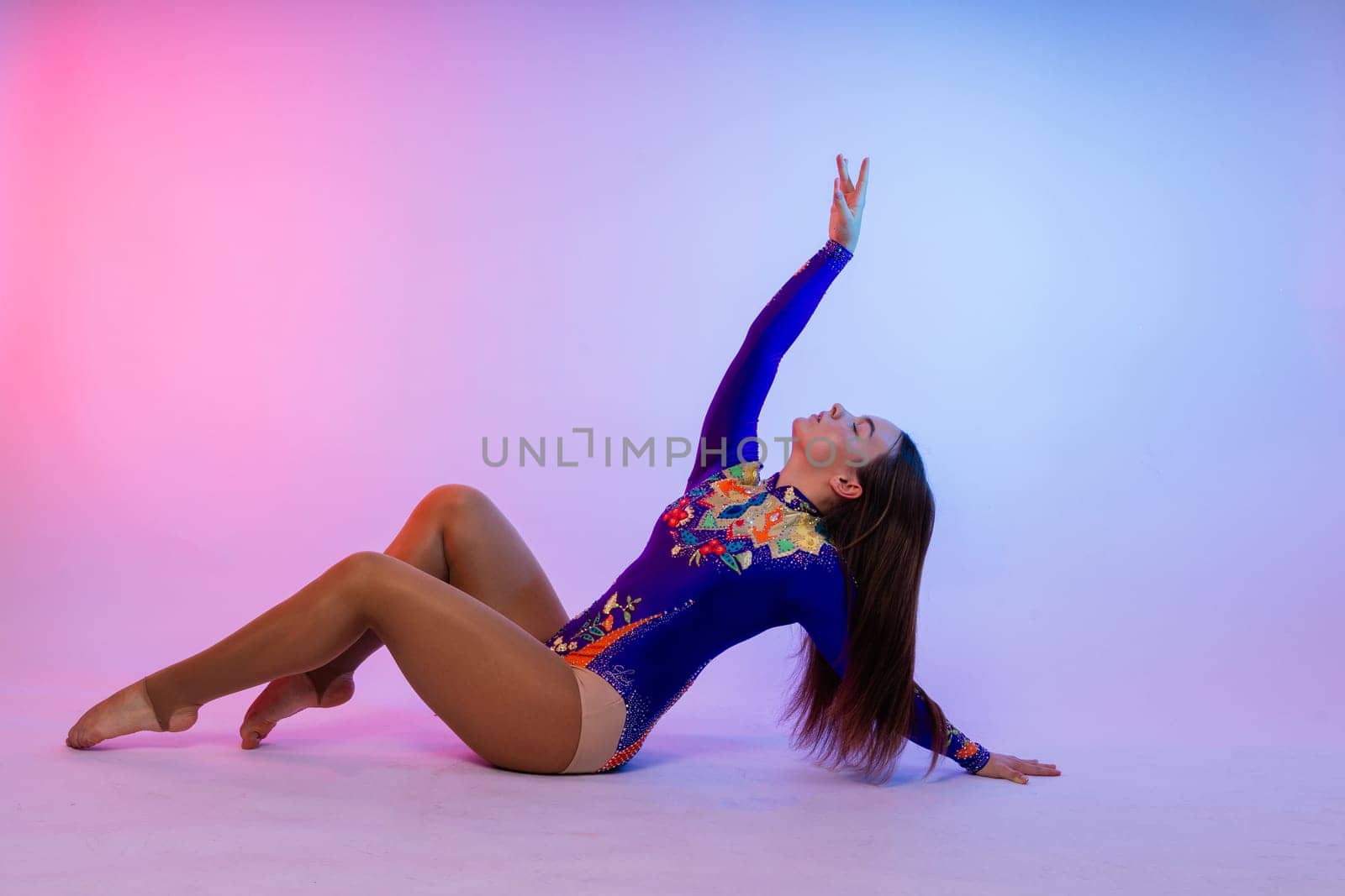 Full length teen girl smiling doing fitness exercises, isolated on a white and dark background