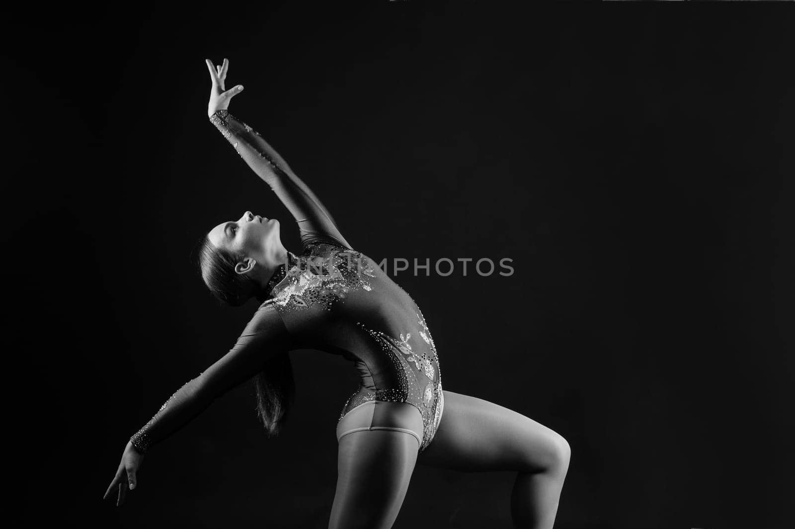 Full length teen girl smiling doing fitness exercises, isolated on white and dark background by Zelenin