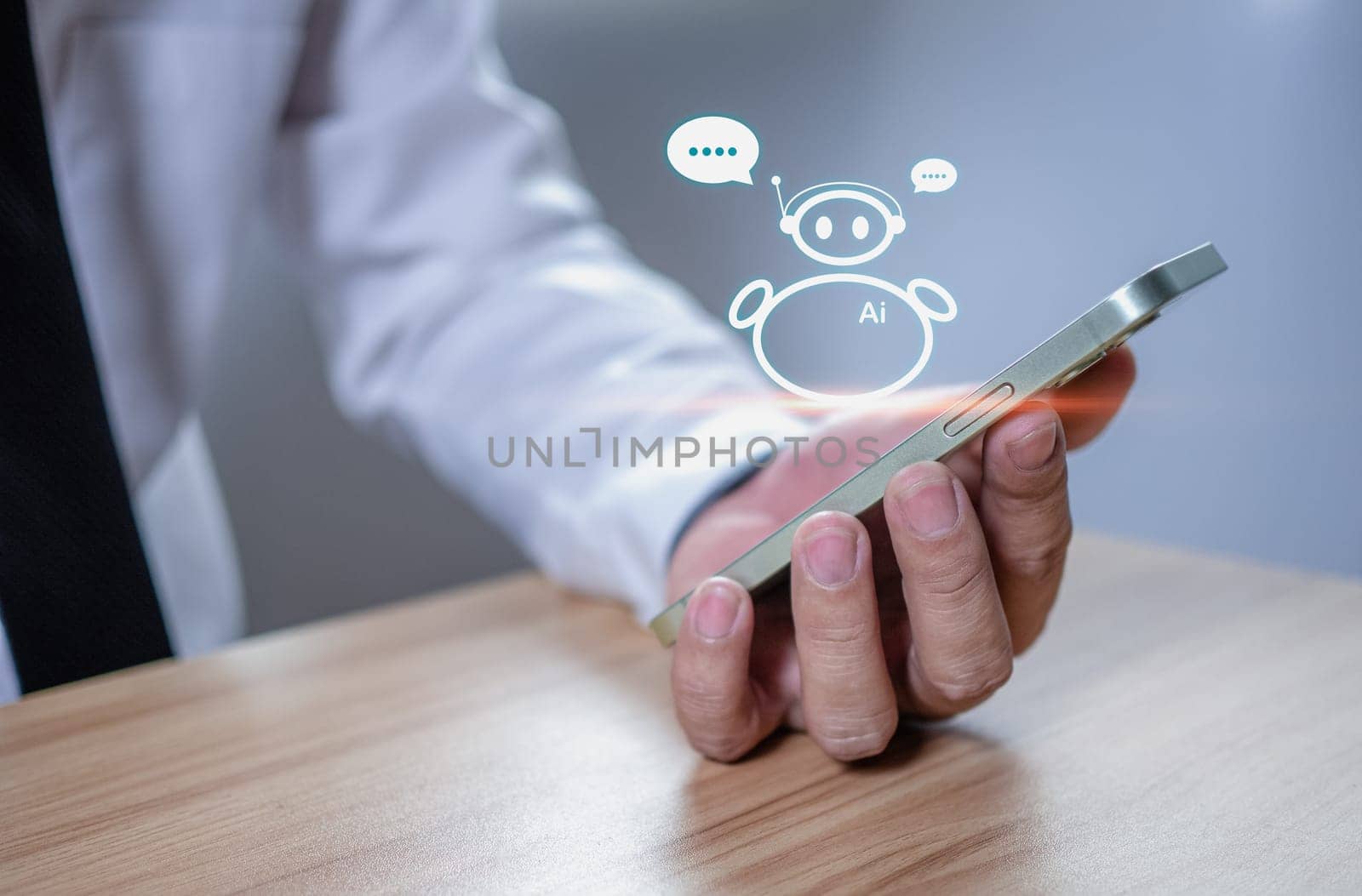 businessman use a smartphone to type live chat, ask, answer with an artificial intelligence system. chat bot. Ai. by Unimages2527