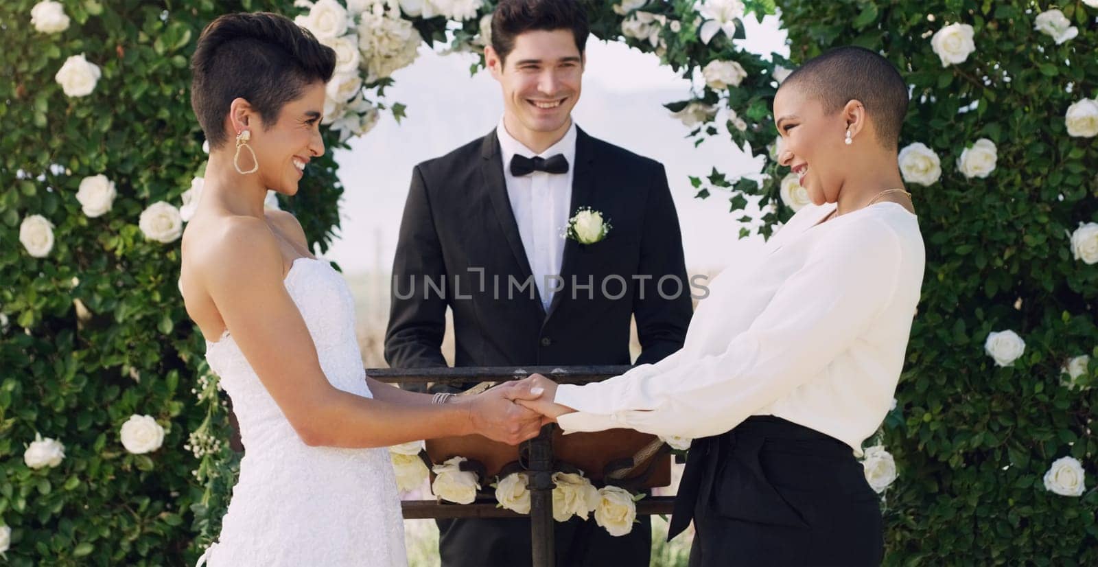 Love, holding hands and gay with lesbian couple at wedding for celebration, lgbtq and pride. Smile, spring and happiness with women at marriage event for partner commitment, romance and freedom by YuriArcurs