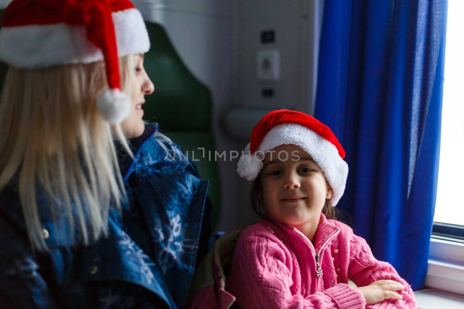 daughter and mother in the train go to the winter resort