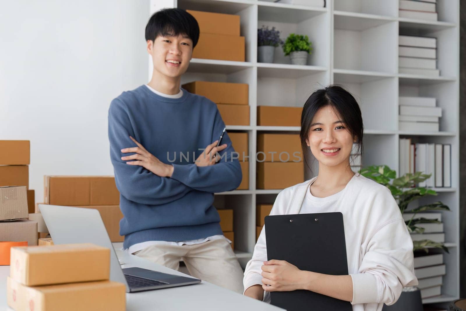 Happy couple people working online with laptop computer and success to selling product online at home office.