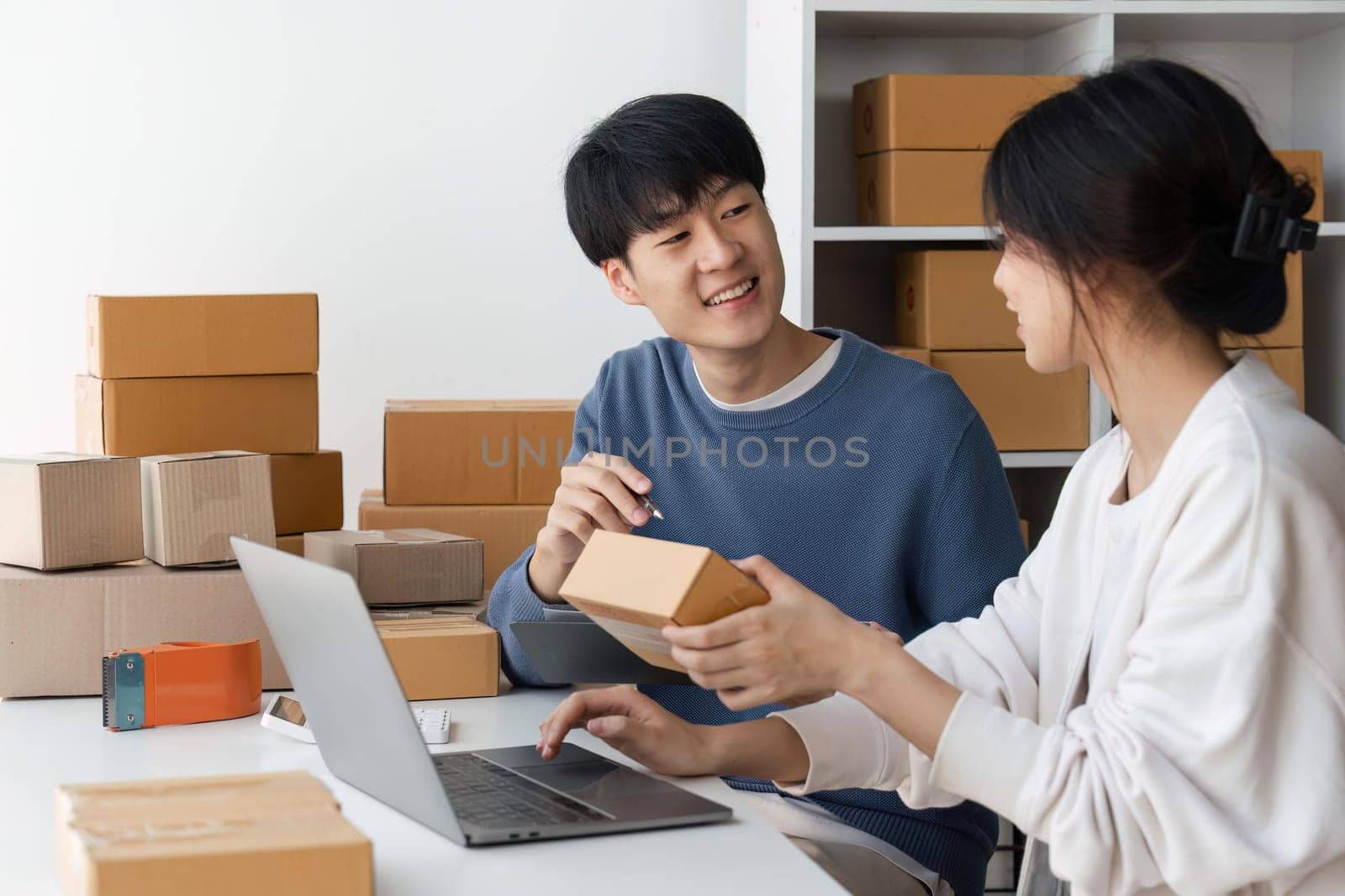 Image of Asian Happy couple people working in home. They are happy and success with their online store. Concept of freelancer startup and online business by nateemee