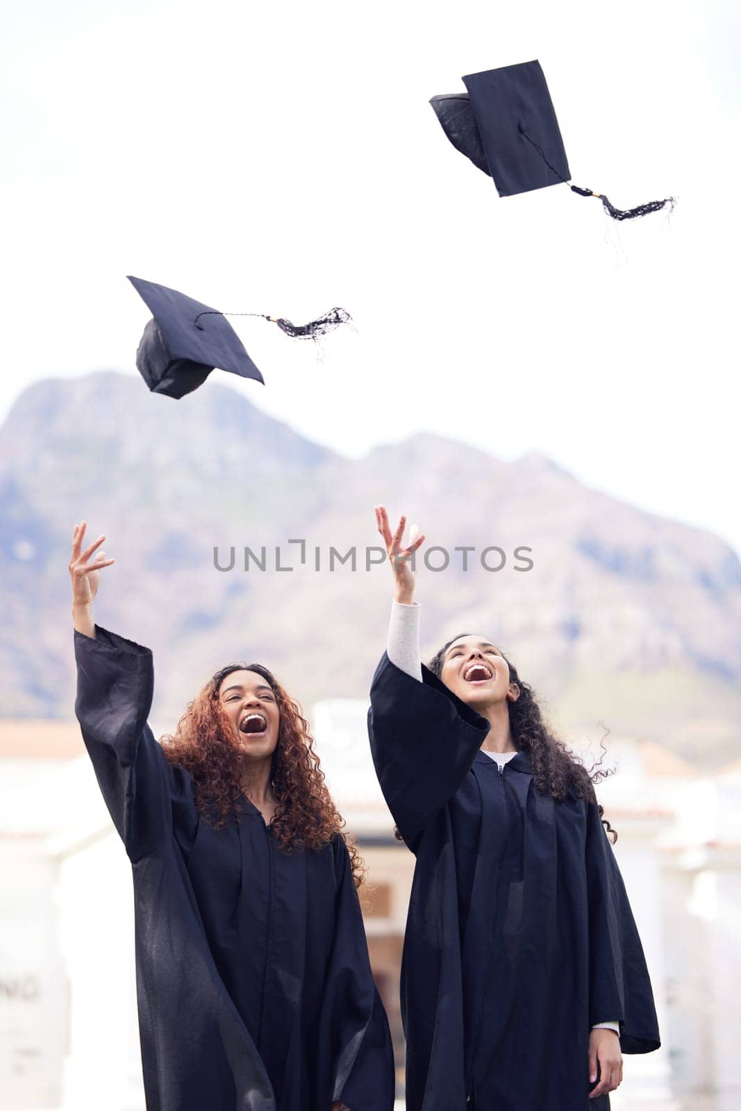 Graduation cap, excited friends and throw in air for celebration, study success and achievement on campus. University students, happy people or women celebrate for college, school and education by YuriArcurs