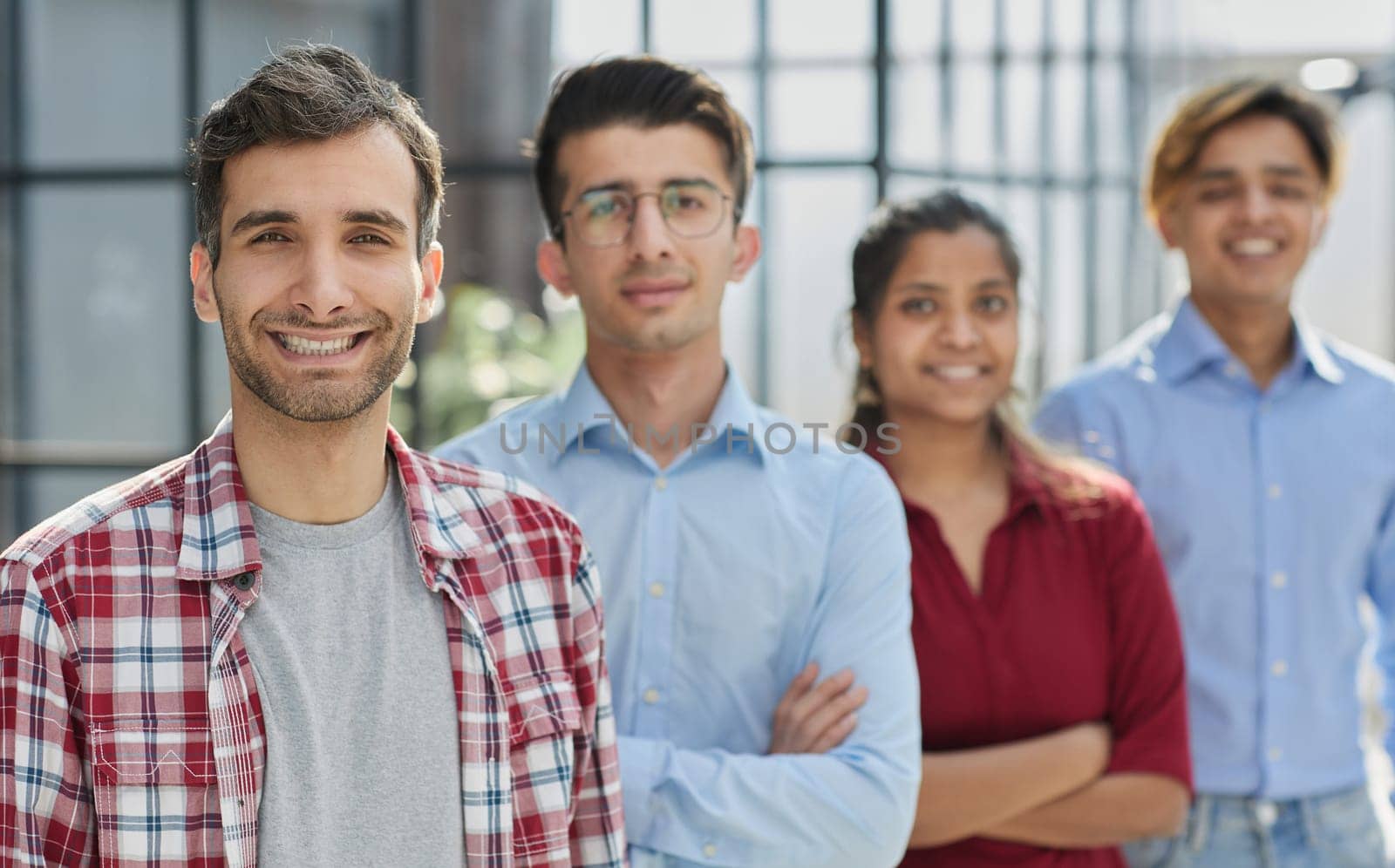 Portrait of smiling business people at window in conference room
