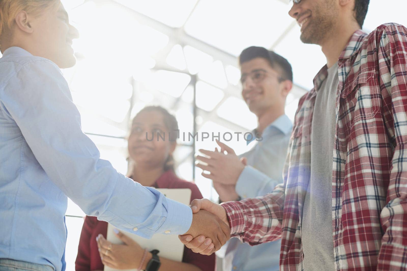 Portrait of a businessman and business woman discussing and cheering with agreement for success.