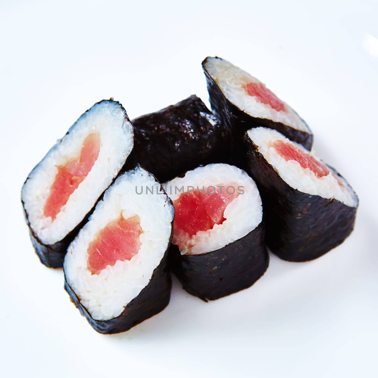 Traditional Japanese maki rolls with tuna on a white background. by sarymsakov