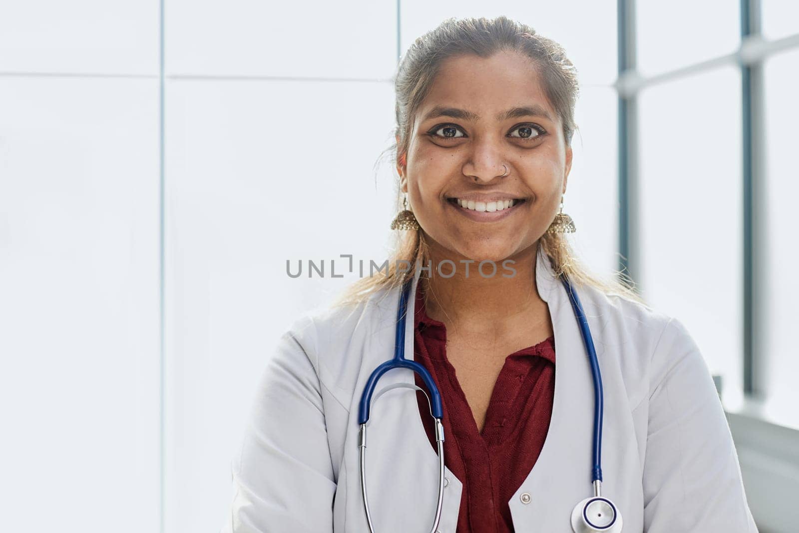 doctor stands in the hospital corridor and looks at the camera
