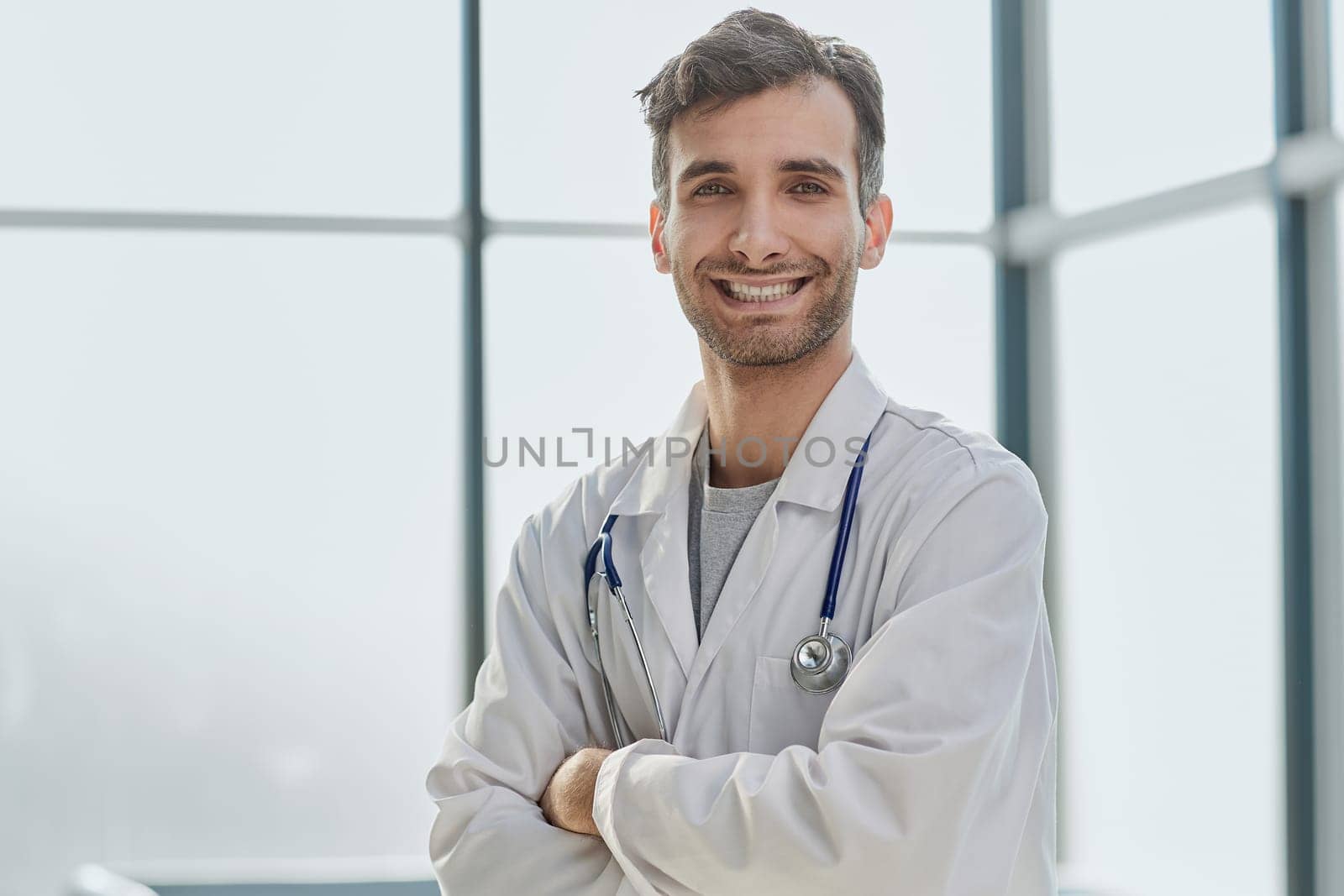 Close-up portrait of a smiling male doctor