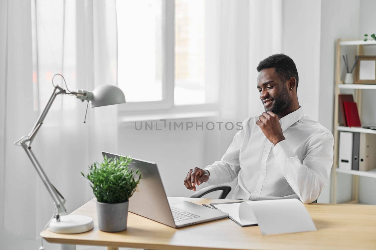 freelancer man online cyberspace computer laptop education american office job african student by SHOTPRIME