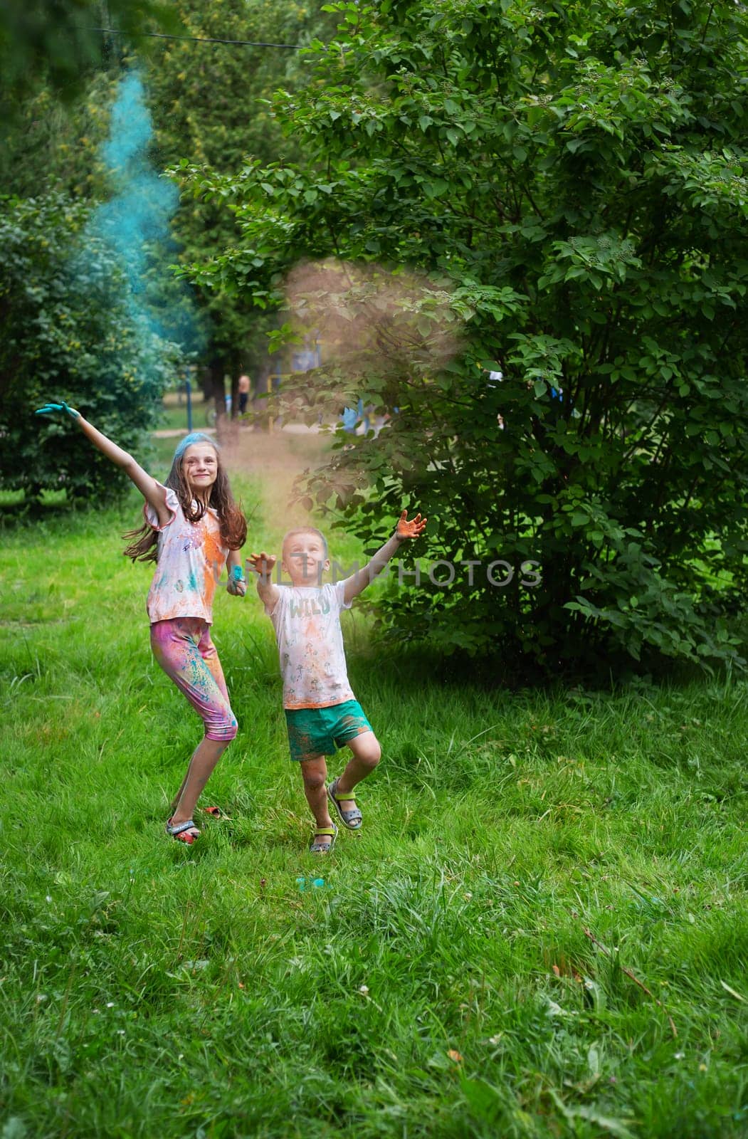 Lviv, Ukraine - July 18, 2021: Color Holi Festival, boy and girl throw colored paint. The holiday comes from India