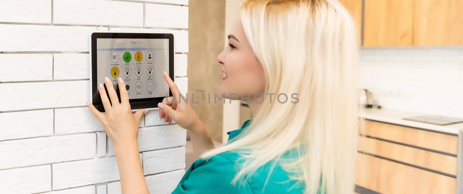 Woman at home using smart screen, automation domestic system.