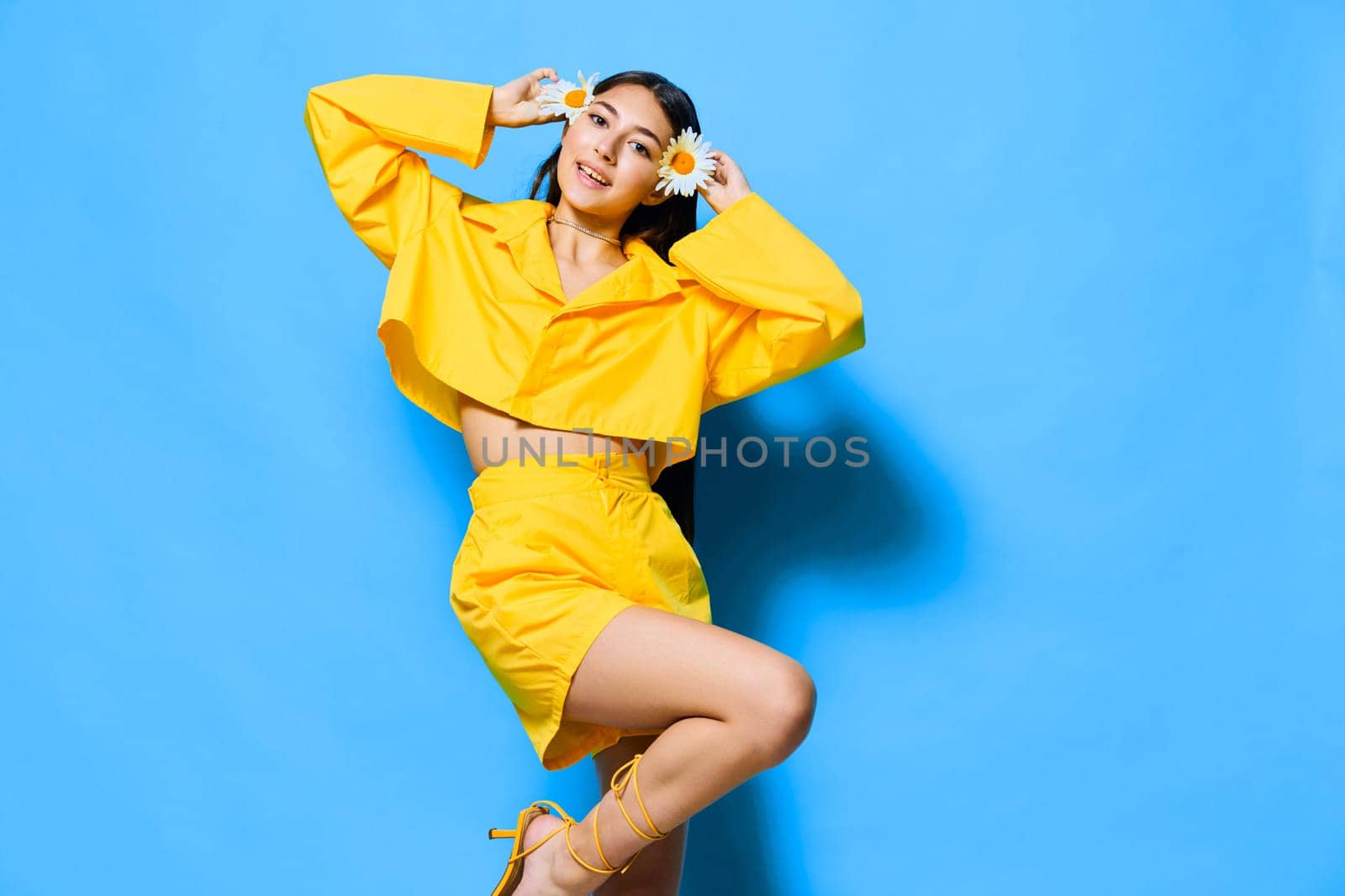 isolated woman flower chamomile blue day beautiful smile stylish emotion female happiness portrait beauty care woman model happy yellow petal pretty young
