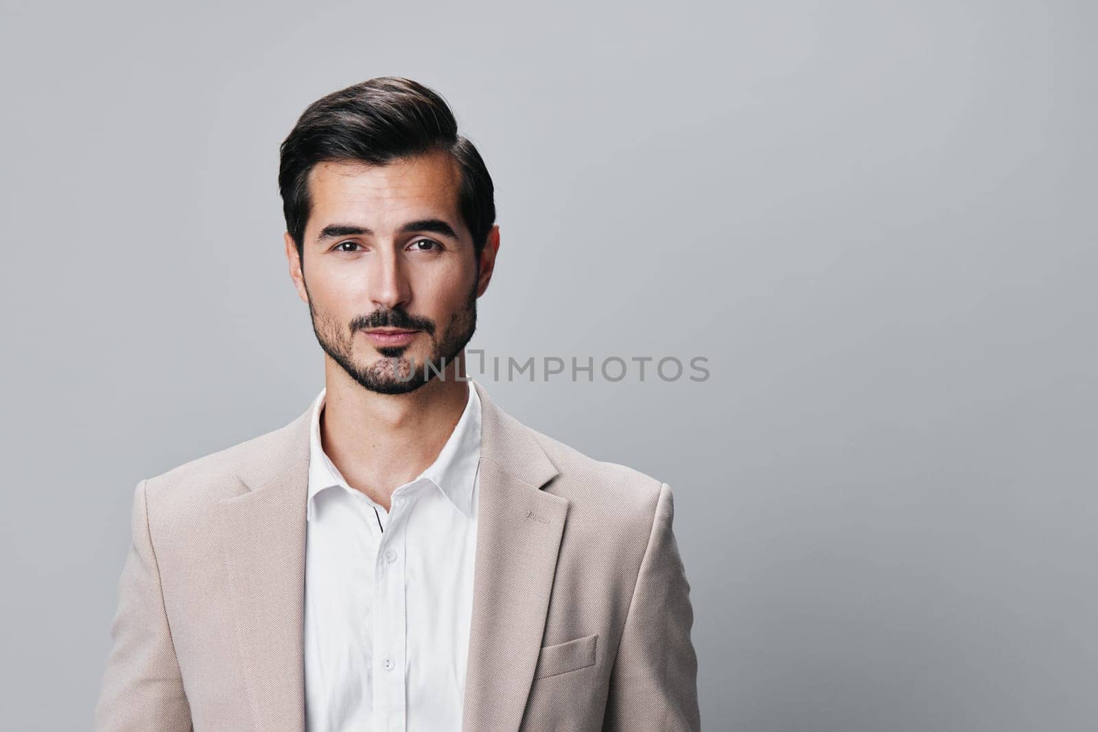 suit man portrait arm smiling young success corporate businessman entrepreneur beige business handsome happy professional stylish posing isolated copyspace office guy