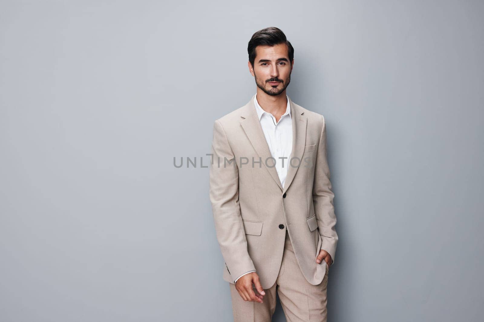 man happy business businessman white male suit portrait young tie grey studio person copyspace posing smiling attractive job beige corporate handsome